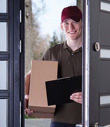 Image of a delivery worker holding a box