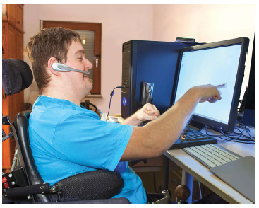 Happy computer user with disabilities using computers and audio devices