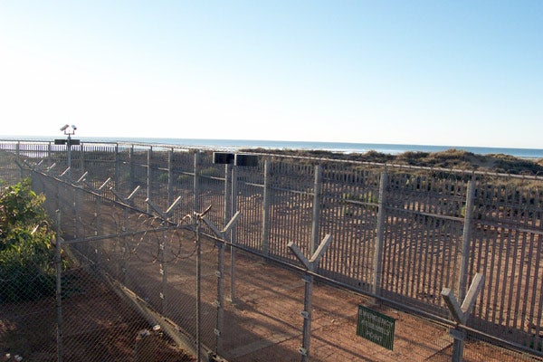 View through the perimeter fence at Port Hedland Immigration Reception and Processing Centre, June 2002. 