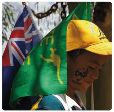 Happy boy of Asian-Australian background on Australia Day with flags and Go Aussie facepaint. (c) Laura MacDougall
