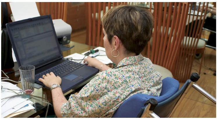 Officer worker in wheelchair using computers