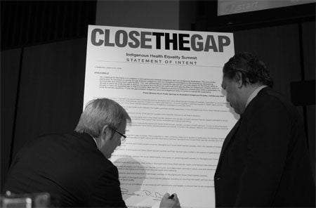 Photo of Rudd signing the Statement of Intent to Close the Gap