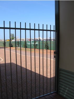 External fence and view to airport, Airport Lodge 