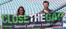 Picture of Cathy Freeman and Ian Thorpe holding a Close the Gap banner
