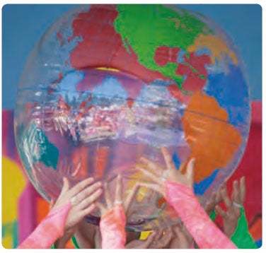 Young people's hands holding a globe of the world aloft (c) Arthur Roy