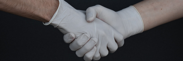 Handshake in white gloves