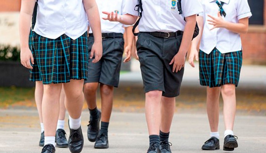 The legs of boys and girls in school uniform