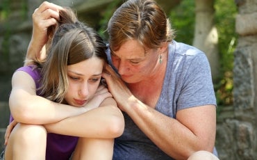 parent consoling sad child