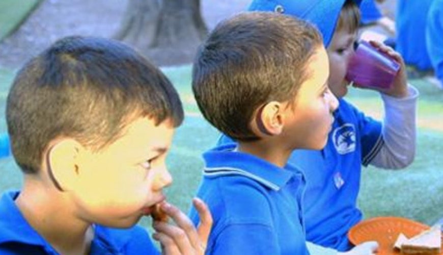 Young children eating lunch in their uniform